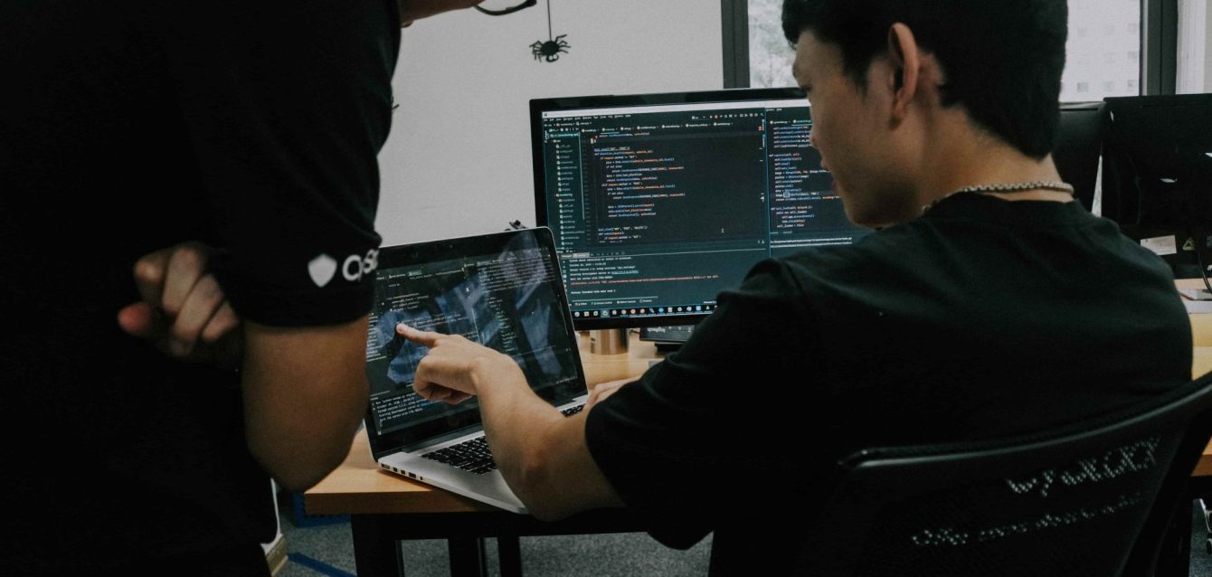 Business team analyzing custom software solutions dashboard showing problem-solving metrics across healthcare retail finance manufacturing industries