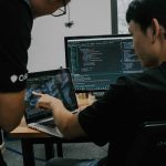 Business team analyzing custom software solutions dashboard showing problem-solving metrics across healthcare retail finance manufacturing industries
